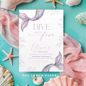 May include: A rectangular birthday invitation card featuring watercolour purple and gold mermaid tails, light pink coral illustrations, and text reading DIVE INTO five Olivia's 4TH BIRTHDAY SATURDAY, JUNE 18TH AT 2PM THOMPSON'S RESIDENCE 136 EAST 24TH STREET, NEW YORK.