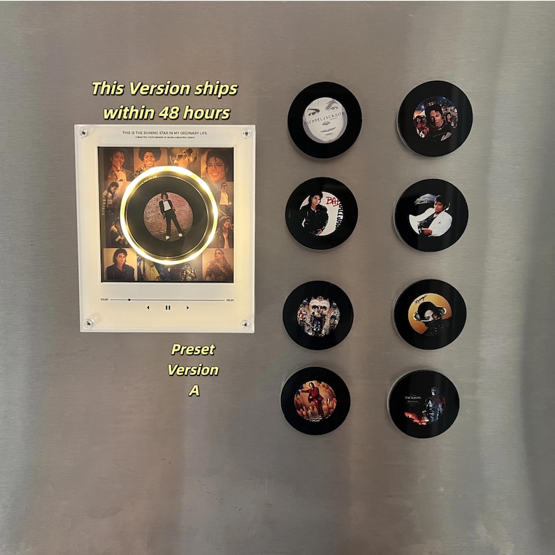 May include: A rectangular white acrylic frame featuring a central circular cutout with a gold rim, displaying a collage of Michael Jackson images and a music player interface. Eight circular black magnets with various Michael Jackson album art designs.
