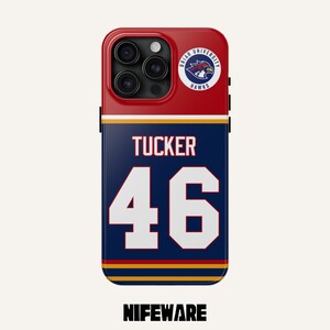May include: A phone case with a red top section featuring the Briar University Hawks logo. The case has a navy blue center with the name "TUCKER" and the number "46" in white. The bottom of the case has the text "NIFEWARE".