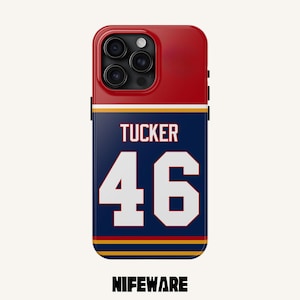 K&ouml;nnte beinhalten: Eine rot-wei&szlig;-blaue Handyh&uuml;lle mit dem Namen "TUCKER" und der Nummer "46" in Wei&szlig;. Die H&uuml;lle hat einen marineblauen Hintergrund mit goldenen und wei&szlig;en Streifen. Der Markenname "NIFEWARE" steht unten.