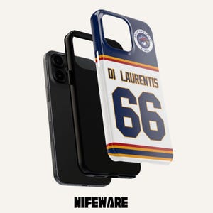 May include: A white and navy blue phone case with the name "Di Laurentis" and the number "66" in navy blue. The case has a team logo at the top and a red, yellow, and blue stripe design. The brand name "NIFEWARE" is at the bottom.