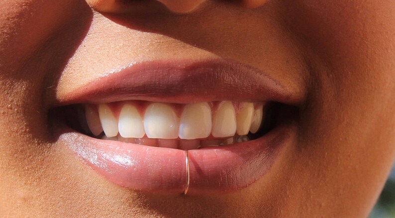 gold lip piercing