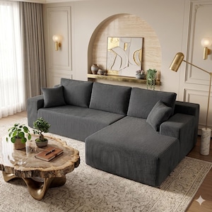 May include: A white ceramic mug with a black handle and the text "But First, Coffee" in a black, handwritten-style font. The mug is on a white surface.