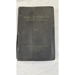 May include: A vintage, dark grey manual titled "Manual of Instruction Customer Engineering" with the IBM logo. The cover also includes the address of International Business Machines Corporation in New York.