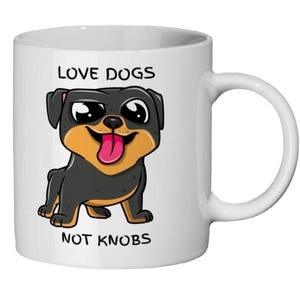 May include: White ceramic mug with a cartoon Rottweiler dog illustration. The dog is black and tan with a pink tongue. The mug has the text "LOVE DOGS NOT KNOBS" in black. A fun gift for dog lovers.