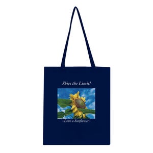 May include: Navy blue tote bag with a sunflower image and the text "Skies the Limit!" and "~Love a Sunflower~". The bag features a blue sky background with a yellow sunflower.