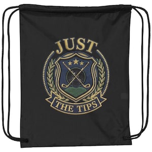 May include: A black drawstring bag featuring an embroidered circular emblem. The design includes a blue shield with crossed golf clubs, three gold stars, and a green base, surrounded by gold laurel leaves with the text JUST THE TIPS.