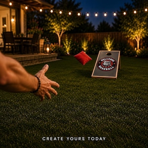 May include: A cornhole board featuring a circular logo with a bulldog illustration and the text BULLDOGS BASEBALL, accompanied by a red bean bag in mid-air. The board has a dark surface with a circular hole at the top. Text reads CREATE YOURS TODAY.