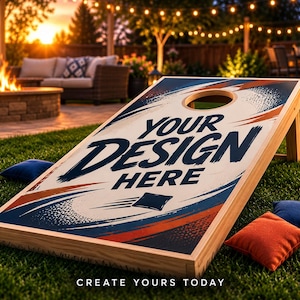 May include: A wooden cornhole board featuring a white surface with navy blue and orange abstract brushstroke graphics, a circular hole, and the text "YOUR DESIGN HERE". Three small square bean bags in navy blue and orange are nearby.