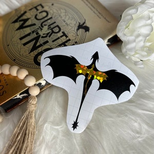 May include: A black silhouette of a dragon with iridescent gold wings on a white background. The dragon is facing right and has a long tail.