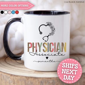 May include: A white ceramic mug with a black handle and interior. The front features a black stethoscope graphic forming a heart with floral accents, the text "PHYSICIAN Associate" in multi-colored leopard print, and the name "samantha" below.