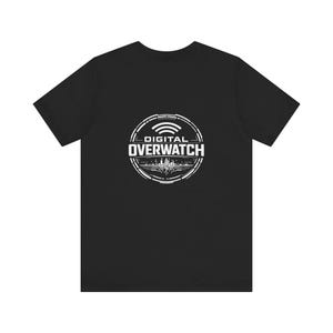 May include: Black t-shirt featuring a white circular graphic with the text "DIGITAL OVERWATCH" and a wifi symbol. The design includes a cityscape silhouette and geometric shapes. The shirt is made of a soft material.