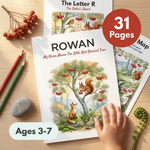 May include: A children's book titled ROWAN My Name Means The Little Red-Berried Tree, featuring a watercolor illustration of a squirrel and fox under a rowan tree. The cover includes text stating 31 Pages and Ages 3-7, with red berries, pencils, and a stone nearby.