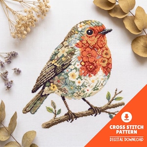 May include: A cross-stitch pattern featuring a bird perched on a branch. The bird is decorated with a floral motif in shades of orange, yellow, and green. The design is set against a white fabric background with visible grid lines for stitching.