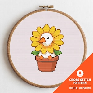 May include: A cross-stitch pattern featuring a duck with a sunflower head in a terracotta pot. The design is set within a wooden embroidery hoop. The text "CROSS STITCH PATTERN DIGITAL DOWNLOAD" is visible in the lower right corner.