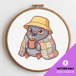 May include: Cross-stitch pattern of a cartoon pigeon wearing a yellow hat and a patchwork blanket, holding a mug of coffee. The design is set in a wooden embroidery hoop. Text on the image reads "PATTERN ONLY DIGITAL DOWNLOAD".