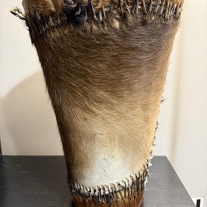 May include: A white ceramic mug with a black handle and the text "But First, Coffee" in a black, bold font. The mug is sitting on a white surface. The mug is a standard size.