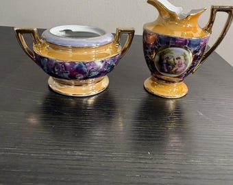 Juego antiguo de jarro para crema y azucarero de porcelana alemana con acabado de mármol brillante.