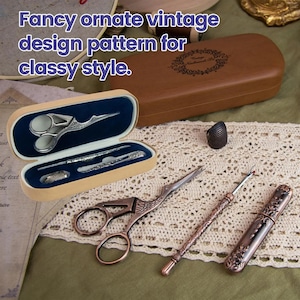 May include: A sewing kit featuring a brown wooden case with a dark blue velvet interior, containing silver-toned stork scissors, a needle case, and a thimble. Additional items include copper-toned stork scissors, a seam ripper, and a needle tube.