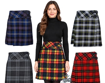 May include: Five pleated skirts in various tartan patterns, including blue, grey, and red colorways. Each skirt features a high waistband with two black side buckles. The text Available in 80+ Tartans is displayed at the top of the image.