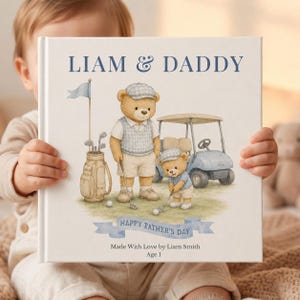 May include: A personalized book cover with the text "LIAM & DADDY" in navy blue. The cover features a watercolor illustration of two teddy bears playing golf, a golf cart, and the text "HAPPY FATHER'S DAY".