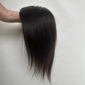 May include: A hair topper piece featuring straight, dark brown hair with a smooth texture. The hair is styled in a sleek, natural-looking manner with a defined top section, designed to provide coverage and volume for the crown area of the head.