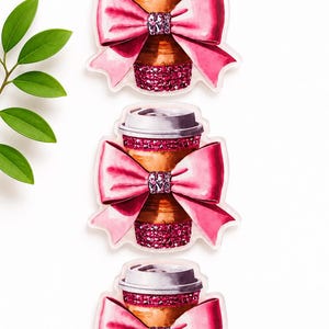 May include: Three identical stickers featuring a brown coffee cup with a lid, decorated with a large pink bow at the center and bands of sparkling pink rhinestones around the top and bottom sections of the cup, arranged vertically in a row.