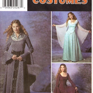 May include: A Simplicity Costumes sewing pattern envelope, number 9891, for sizes RR 14, 16, 18, 20. The cover displays three variations of long-sleeved, floor-length dresses with flared sleeves, featuring a grey dress, a light blue dress, and a dark red dress.