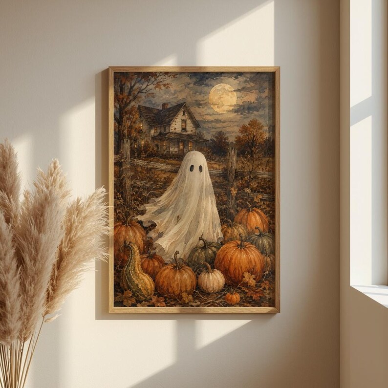 May include: A framed wall art print depicting a white ghost standing in a pumpkin patch at night. In the background, a house sits under a full moon in a cloudy sky. The foreground is filled with various orange pumpkins and a green gourd.