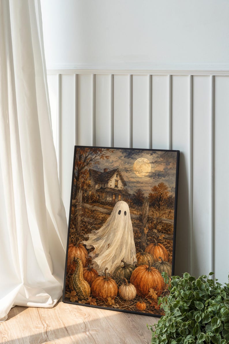May include: A framed rectangular wall art print featuring a white ghost standing in a pumpkin patch at night. The scene includes a rustic wooden fence, a house in the background, and a full moon in the sky, all rendered in warm autumn tones.