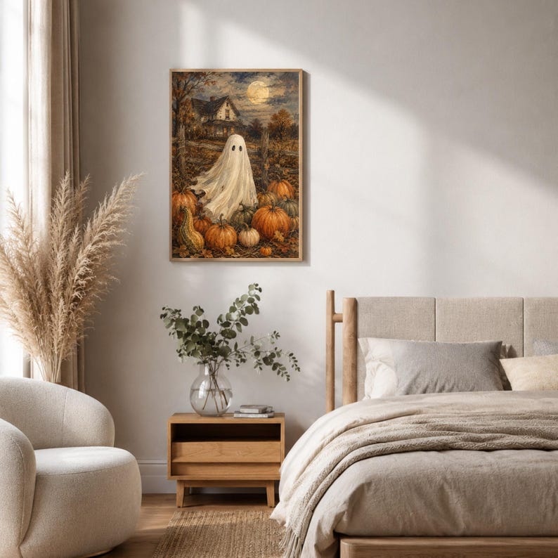 May include: A rectangular wall art print featuring a white ghost standing in a pumpkin patch at night. The scene includes a full moon, a dark house in the background, and numerous orange pumpkins scattered across the ground in a rustic setting.
