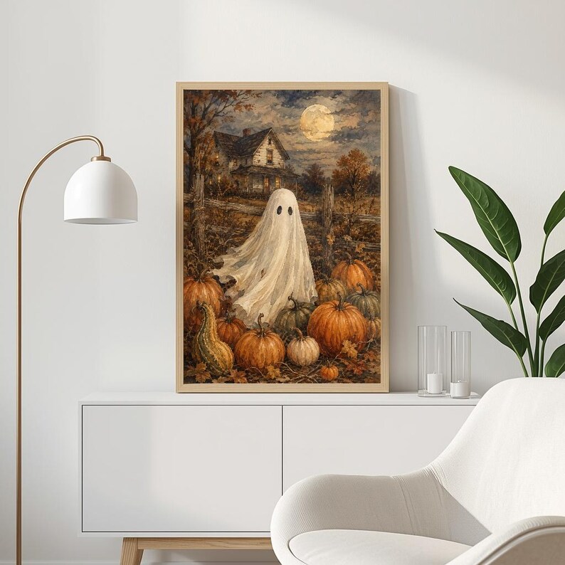 May include: A rectangular wall art print featuring a white ghost standing in a pumpkin patch at night. In the background, a house sits under a full moon and a cloudy sky. The scene includes numerous orange pumpkins and a gourd on the ground.