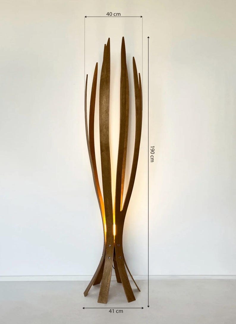May include: A tall, wooden floor lamp with a unique, organic design. The lamp is approximately 75 inches tall and 16 inches wide, featuring vertical wooden slats that curve upwards. The lamp's base is 16 inches wide. The lamp emits a warm, inviting glow.