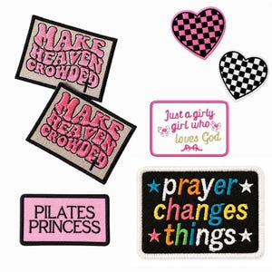 May include: A collection of embroidered patches including two rectangular patches with the text MAKE HEAVEN CROWDED, one pink rectangular patch reading PILATES PRINCESS, one white patch reading Just a girly girl who loves God, two heart patches, and one black patch reading prayer changes things.