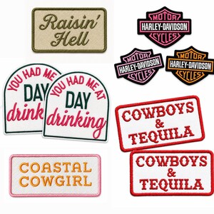 May include: A collection of embroidered fabric patches featuring various designs and text including Raisin' Hell, Harley-Davidson logos, You Had Me At Day Drinking, Cowboys & Tequila, and Coastal Cowgirl in assorted colors like pink, orange, red, and green.