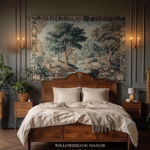 May include: A bedroom with a wooden bed, cream bedding, and pillows. A forest scene tapestry hangs above the bed. The room includes plants, sconces, and nightstands. The text "WILLOWBROOK MANOR Fine Art Home Decor" is visible at the bottom of the image.