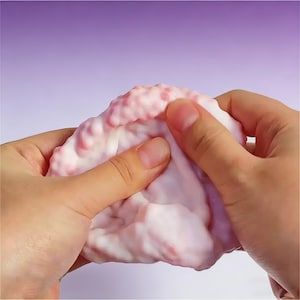 May include: A set of three ceramic mugs with a speckled, matte finish. The mugs are in shades of cream, light gray, and dark gray. Each mug has a simple, minimalist design and a rounded handle.