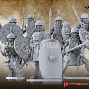 May include: A group of ten unpainted gray miniature soldier figurines standing on individual circular bases. Each figure wears a helmet and armor, holding a spear and a round or rectangular shield. The text War Bear Studios is visible.