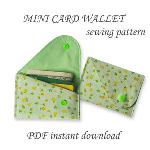 May include: Two mini card wallets, one open and one closed, made of light green fabric with a yellow floral pattern. The open wallet displays cards and cash. The wallets have green snap closures. Text reads "MINI CARD WALLET sewing pattern" and "PDF instant download."