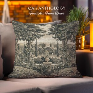 May include: A square throw pillow featuring a monochromatic toile-style print of a landscape with trees, a garden, and a distant building. The text OAK ANTHOLOGY Fine Art Home Decor is printed in white above the pillow on the background.