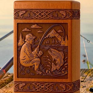 May include: A wooden box with a detailed carving of a fisherman reeling in a fish. The box is rectangular with decorative borders featuring fish and Celtic knot designs. The background shows a lake and mountains.