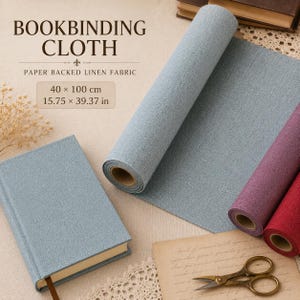 May include: Bookbinding cloth made of paper-backed linen fabric, featuring a light blue roll and a matching blue book, alongside purple and red rolls. The text reads BOOKBINDING CLOTH PAPER BACKED LINEN FABRIC 40 x 100 cm 15.75 x 39.37 in.