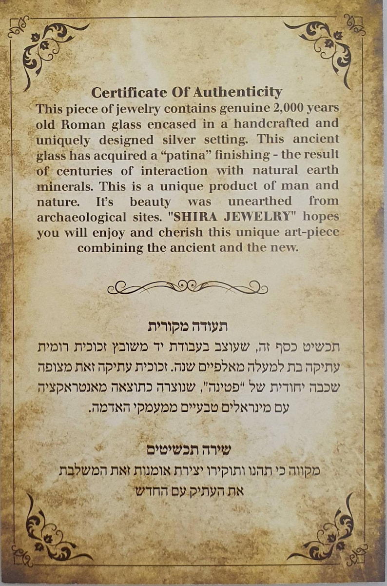May include: A certificate of authenticity for a piece of jewelry. The text describes a handcrafted silver setting with 2,000-year-old Roman glass. The glass has a patina finish from interaction with minerals. The text includes the phrase "SHIRA JEWELRY".