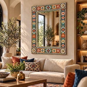 May include: A rectangular wall mirror featuring a decorative frame with colorful, repeating geometric and floral tile patterns in shades of orange, blue, green, and white, accented by gold-toned corner blocks with circular floral motifs.