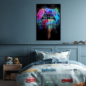 May include: A vertical wall art print featuring a vibrant, multicolored video game controller graphic against a black background. The design incorporates bright splashes of pink, blue, and yellow paint drips that extend downward from the controller.