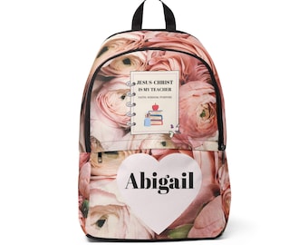 May include: A backpack featuring a pink floral pattern with a central rectangular graphic that reads JESUS CHRIST IS MY TEACHER FAITH, WISDOM, PURPOSE with an apple and books icon. Below is a white heart shape with the name Abigail printed in black.