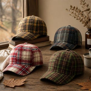 May include: Four baseball caps featuring various plaid patterns in yellow, blue, red, and green. Each cap is constructed from a textured fabric and includes a curved brim, a button at the top, and stitched eyelets for ventilation.