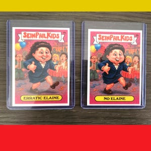 May include: Two trading cards featuring a cartoon of a woman in a blue suit, with the text "SEINPAIL KIDS" at the top. One card reads "ERRATIC ELAINE" and the other reads "NO ELAINE". The background shows a party scene.