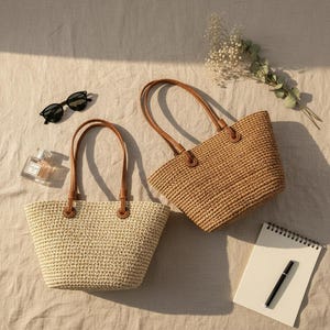 May include: Two woven straw tote bags with brown leather handles. One bag is a light beige color, and the other is a medium brown. Sunglasses, perfume, a notepad, and a pen are also visible.