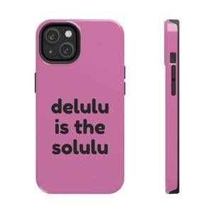 May include: A pink phone case with the text "delulu is the solulu" in black. The case has a black camera module and black side buttons. The phone case is shown from the front and side.